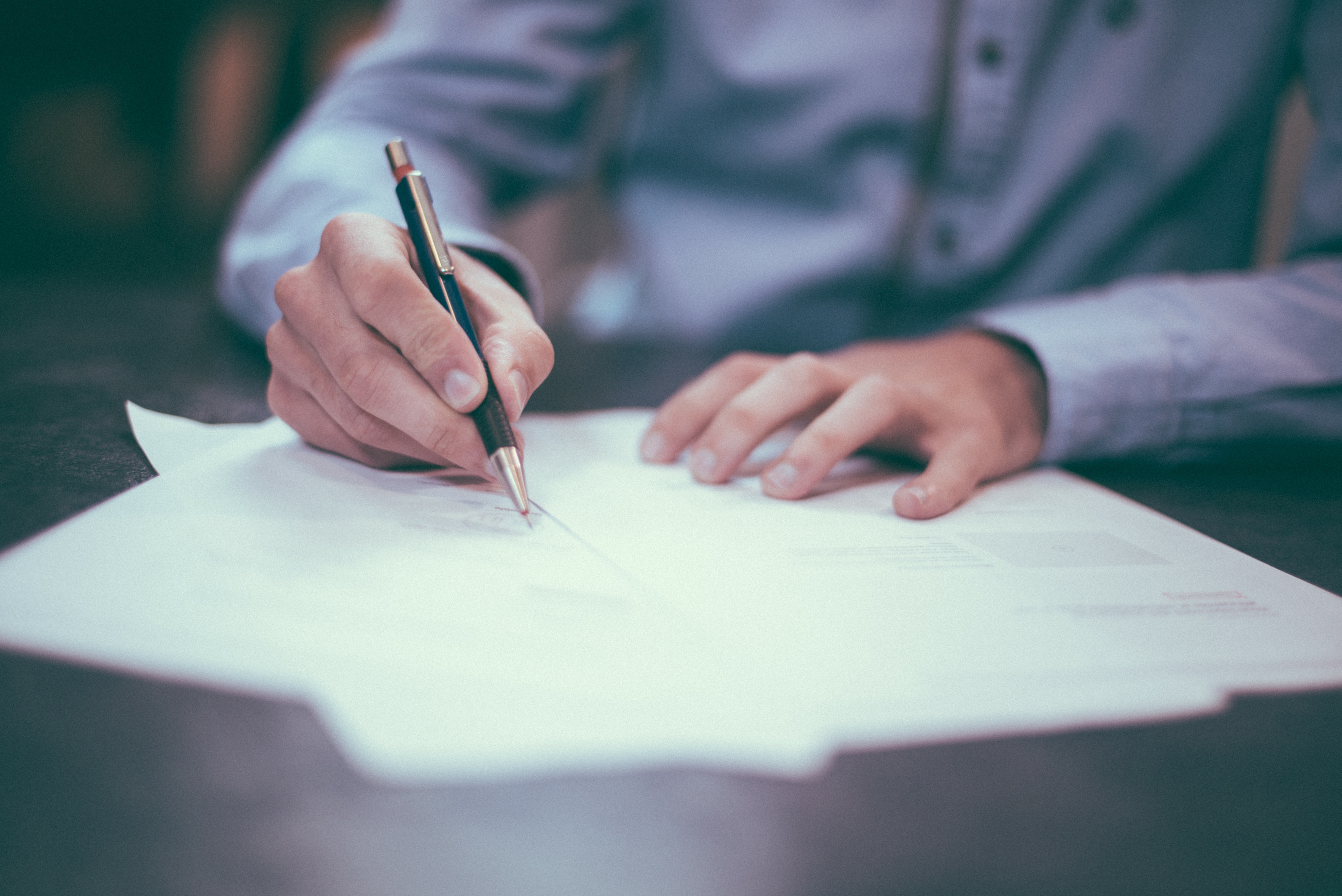 A Homeowner signing a Construction Contract | Contracts Specialist